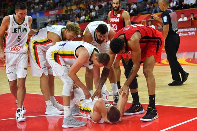 (190903) -- DONGGUAN, Sept. 3, 2019 -- Arnas Butkevicius (Bottom) of Lithuania gets injured during the group H match between Lithuania and Canada at the 2019 FIBA World Cup in Dongguan, south China s Guangdong Province, Sept. 3, 2019. ) (SP)CHINA-DONGGUAN-BASKETBALL WM FIBA WORLD CUP-GROUP H-LITHUANIA VS CANADA (CN) ZhuxZheng 