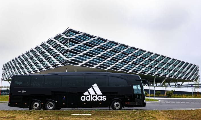 Adidas bus in front of the Arena Adidas Arena, administrative building adidas AG administration building reminiscent of a football arena, football stadium, is 52,000 sqm in size and accommodates more than 2,000 employees is part of the World of Sports Herzogenaurach on 29 07 2019
