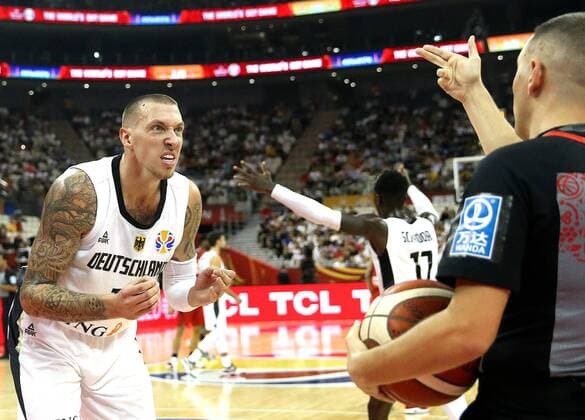 (190909) -- SHANGHAI, Sept. 9, 2019 -- Daniel Theis (L) of Germany talks to the referee during the Group P match between Germany and Canada at the 2019 FIBA World Cup in Shanghai, east China, Sept. 9, 2019. ) (SP)CHINA-SHANGHAI-BASKETBALL-FIBA WORLD CUP-GROUP P-GER VS CAN(CN) ChenxFei 