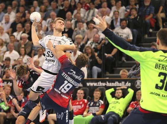 Photo Goalscoring by Nikola Bilyk white against Marius Steinhauser Flensburg Handball Men 1 Bundesliga at Do 12 09 2019 THW Kiel SG Flensburg 28 24