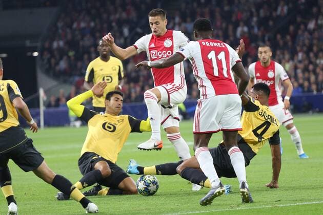 September 17, 2019: AMSTERDAM, NETHERLANDS - SEPTEMBER 17, 2019: Dusan Tadic (Ajax) and Gabriel (Lille) battle the ball during the 1st match of the 2019 20 UEFA Champions League Final Group Round between AFC Ajax (Netherlands) and Lille OSC (France) at Johan Cruijff ArenA. Sports News - September 17, 2019 - ZUMAm251 20190917_zsp_m251_219 Copyright: xFedericoxGuerraxMaranesix