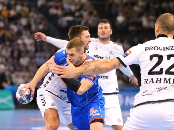 Photo Goal throw by Alexsander Shkurinskiy against Harald Reinkind Kiel Handball Men Champions League at Mi 25 09 2019 THW Kiel HC Meshkov Brest