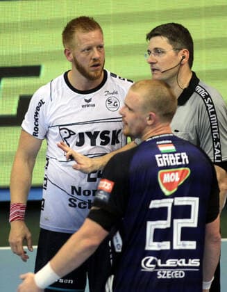 28.09.2019 Szeged(Hungary) MOL Pick Szeged-SG Flensburg-Handewitt EHF Champions League men s handball Jim Gottfridsson(L)SG Flensburg-Handewitt during match in conversation with Peter Brunovsky(R) Slovakian referee beside Matej Gaber(front) MOL Pick Szeged defence players : 