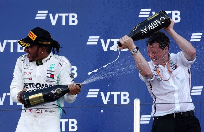 SOCHI, RUSSIA â€“ SEPTEMBER 29, 2019: Mercedes AMG Petronas F1 Team driver Lewis Hamilton (L) of the United Kingdom and Mercedes chief engineer Fred Judd spray champagne on the podium at the 2019 Formula One Russian Grand Prix victory ceremony at the Sochi Autodrom racing circuit. Sergei Fadeichev TASS  TS0BCCFE