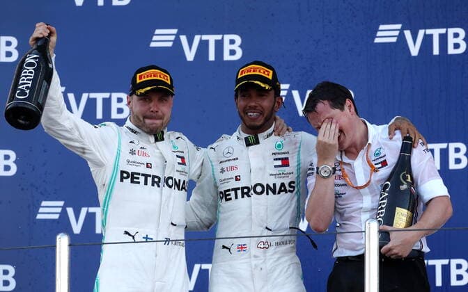 SOCHI, RUSSIA â€“ SEPTEMBER 29, 2019: Mercedes AMG Petronas F1 Team drivers Valtteri Bottas of Finland, second-placed, Lewis Hamilton of the United Kingdom and Mercedes chief engineer Fred Judd (L-R) spray champagne on the podium at the 2019 Formula One Russian Grand Prix victory ceremony at the Sochi Autodrom racing circuit. Sergei Fadeichev TASS  TS0BCCFF