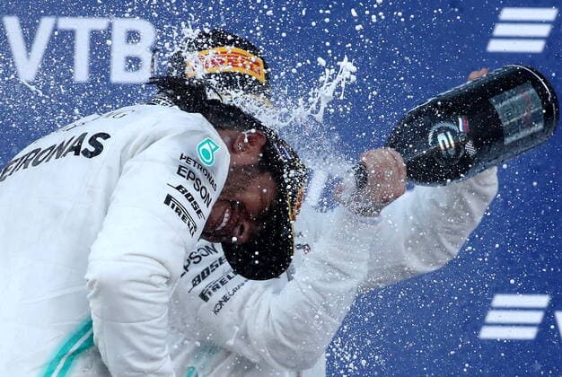 SOCHI, RUSSIA â€“ SEPTEMBER 29, 2019: Mercedes AMG Petronas F1 Team drivers Valtteri Bottas (R) of Finland, second-placed, and Lewis Hamilton of the United Kingdom, first-placed, spray champagne on the podium during the 2019 Formula One Russian Grand Prix victory ceremony at the Sochi Autodrom racing circuit. Sergei Fadeichev TASS  TS0BCD07