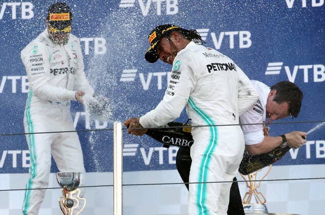 SOCHI, RUSSIA â€“ SEPTEMBER 29, 2019: Mercedes AMG Petronas F1 Team drivers Valtteri Bottas of Finland, second-placed, Lewis Hamilton of the United Kingdom and Mercedes chief engineer Fred Judd (L-R) spray champagne on the podium at the 2019 Formula One Russian Grand Prix victory ceremony at the Sochi Autodrom racing circuit. Sergei Fadeichev TASS  TS0BCD08