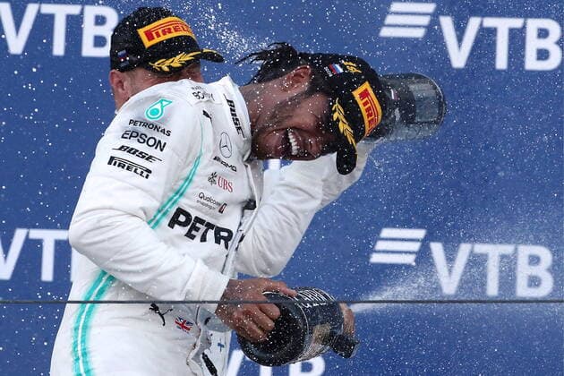SOCHI, RUSSIA â€“ SEPTEMBER 29, 2019: Mercedes AMG Petronas F1 Team drivers Valtteri Bottas (L) of Finland, second-placed, and Lewis Hamilton of the United Kingdom, first-placed, spray champagne on the podium during the 2019 Formula One Russian Grand Prix victory ceremony at the Sochi Autodrom racing circuit. Sergei Fadeichev TASS  TS0BCD3E