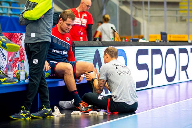 Bietigheim, Germany 06 October 2019 2 BL 19 20 SG BBM Bietigheim vs HSV Handball Hamburg Michael Kraus SG BBM Bietigheim Injured injury pain, being treated on the calf Bietigheim Egetrans Arena Baden Württemberg Germany