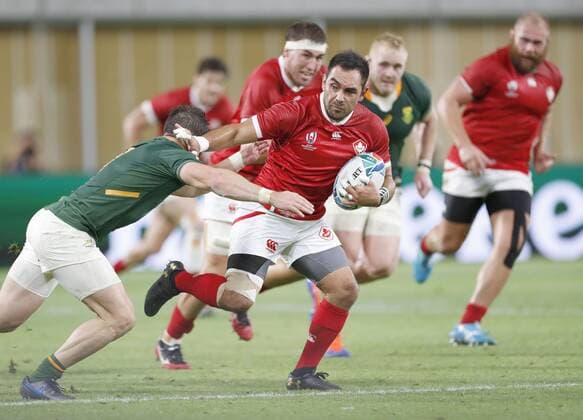 Rugby World Cup in Japan: S. Africa v Canada Phil Mack of Canada evades a tackle during the first half of a Rugby World Cup Pool B match against South Africa on Oct. 8, 2019, in Kobe, western Japan. 