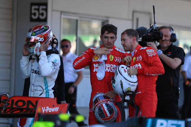 13th October 2019; Suzuka Circuit, Suzuka City, Japan; Formula One Japanese Grand Prix, Race Day; Scuderia Ferrari, Sebastian Vettel talks with team mate Charles Leclerc - Editorial Use  ActionPlus12176848 LeannexBoon