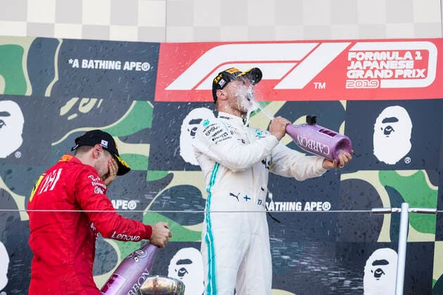 13th October 2019; Suzuka Circuit, Suzuka City, Japan; Formula One Japanese Grand Prix, Race Day; Valtteri Bottas and Sebastian Vettel spray champagne on the podium after the race - Editorial Use  ActionPlus12176878 StephenxBlackberry