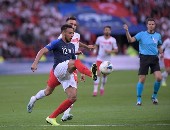 Kenan Karaman of Turkey and Corentin Tolisso 12 of France during the European Championship, EM, Europameisterschaft qualification Group H Match between France and Turkey at Stade de France in Saint-denis , France on October 14 , 2019. 
