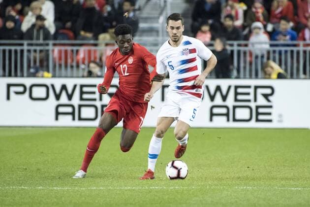 October 15, 2019, Toronto, Ontario, Canada: Alphoson Davies (12) and Daniel Lovitz (5) in action during the Canada vs USA - Nations League qualifier game Canada vs USA - Nations League qualifier - ZUMAm154 20191015_zap_m154_019 Copyright: xAngelxMarchinix