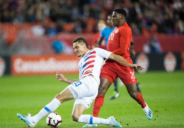 (191016) -- TORONTO, Oct. 16, 2019 -- Jonathan David (R) of Canada vies with Aaron Long of the United States during their League A Group A match of the 2019-2020 Concacaf Nations League at BMO Field in Toronto, Canada, Oct. 15, 2019. (Photo by Xinhua) (SP)CANADA-TORONTO-SOCCER-CONCACAF NATIONS LEAGUE-CAN VS USA ZouxZheng 