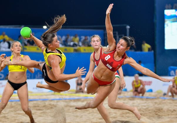 (191017) -- DOHA, Oct. 17, 2019 (Xinhua) -- Melanie Fuglsbjerg (L, front) of Denmark vies with Toth Emese Szilvia (R, front) of Hungary during the women s Beach Handball final between Hungary and Denmark at the 1st ANOC World Beach Games Qatar 2019 in Doha, capital of Qatar, on Oct. 16, 2019. (Photo by Nikku Xinhua) (SP)QATAR-DOHA-WORLD BEACH GAMES-BEACH HANDBALL 