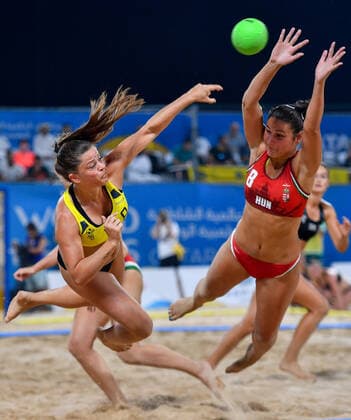 (191017) -- DOHA, Oct. 17, 2019 (Xinhua) -- Fuglsbjerg Melanie (L) of Denmark vies with Toth Emese Szilvia of Hungary during the women s Beach Handball final between Hungary and Denmark at the 1st ANOC World Beach Games Qatar 2019 in Doha, capital of Qatar, on Oct. 16, 2019. (Photo by Nikku Xinhua) (SP)QATAR-DOHA-WORLD BEACH GAMES-BEACH HANDBALL 