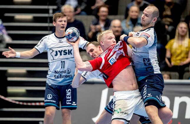 Aalborg Handbold meets SG Flensburg Handewitt in a Champions League mens handball match played in Jutlander Bank Arena, Aalborg, Sunday 20 October 2019 End 31 28 Magnus Saugstrup 14 Aalborg and Simon Hald Jensen 5, in the background Lasse Svan 11 and Janus Smaráson 3 Aalborg and Holger Glandorf 9, Aalborg,  Copyright: FotografxRenéxSchütze RenéxSchützex COP107 spdk20191020-193049-L