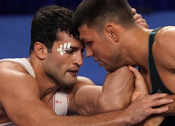 (191025) -- BEIJING, Oct. 25, 2019 -- Metehan Basar (L) of Turkey competes with Denis Maksymilian Kudla of Germany during a wrestling match at the 7th International Military Sports Council (CISM) Military World Games in Wuhan, capital of central China s Hubei Province, Oct. 24, 2019. ) XINHUA PHOTOS OF THE DAY WanxXiang 