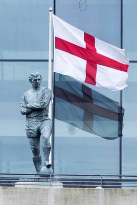 April 27, 2018 - London, London, United Kingdom - The England flag flies behind the statue of Bobby Moore outside Wembley Stadium. It is reported that the Football Association (FA) has received a bid of GBP800m from Shahid Khan, owner of Fulham FC and the Jacksonville Jaguars NFL, American Football Herren, USA franchise, to purchase the stadium. London United Kingdom  - ZUMAt138 20180427_zap_t138_005 Copyright: xRayxTangx April 27 2018 London London United Kingdom The England flag flies behind the statue of Bobby  - ZUMA5 82987195st Copyright: xRayxTangx