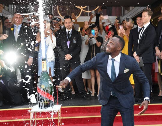 RACING MELBOURNE CUP COLOUR, Usain Bolt opens a bottle of champagne in the Birdcage on Melbourne Cup Day at Flemington Racecourse in Melbourne, Tuesday, November 5, 2019. ( NO ARCHIVING, EDITORIAL USE ONLY, NO USE IN BOOKS WITHOUT CONSENT MELBOURNE VIC AUSTRALIA  Copyright: xJULIANxSMITHx 20191105001430941037