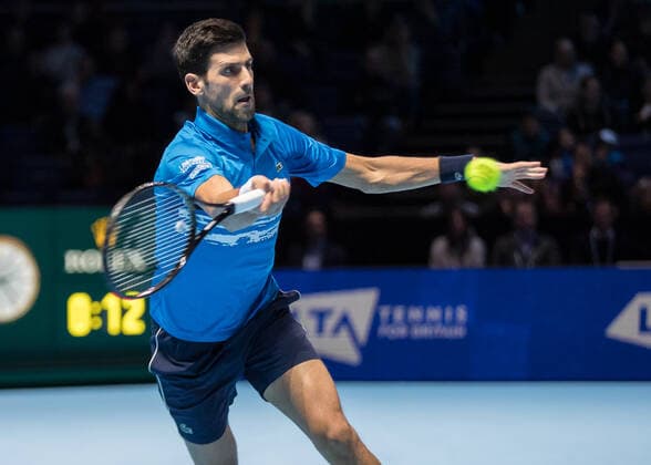 Tennis - 2019 Nitto ATP, Tennis Herren Finals at The O2 - Day One Singles Group Bjorn Borg: Novak Djokovic vs. Matteo Berrettini Novak Djokovic (Serbia) reaches across to make the passing shot COLORSPORT DANIEL BEARHAM  csp_ATPFls_D1_101119_