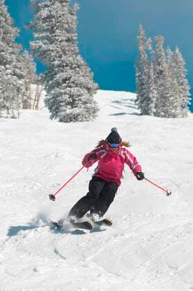 Teenage Girl Skiing Down a Slope 03B61983