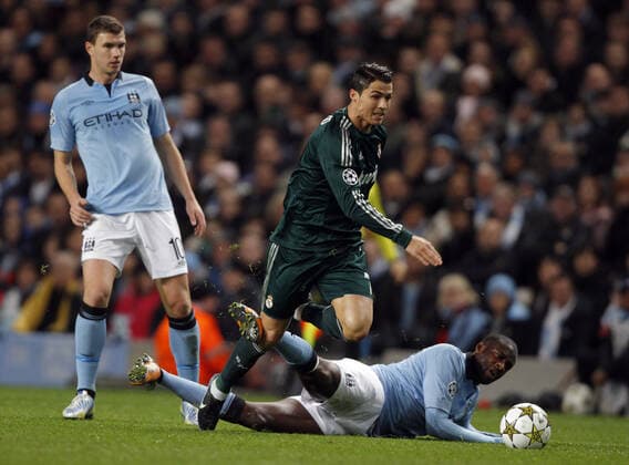 Yaya Toure Fouls Cristiano Ronaldo Manchester City V Real Madrid Cf Manchester City V Real Madrid Cf Uefa Champions League Group D Etihad Stadium, Manchester, England 21 November 2012  Copyright: MaryxEvansxAllstarxRichardxSellers 12544462 editorial use only