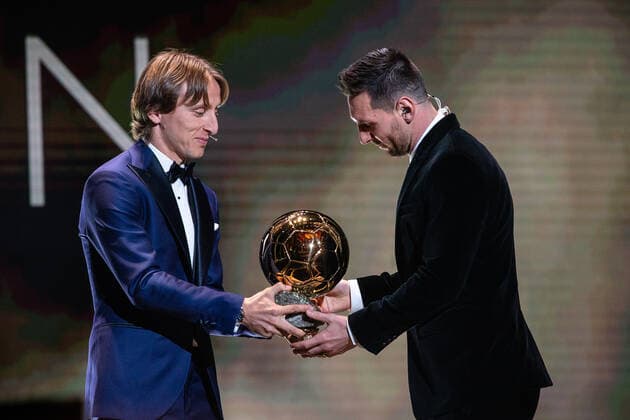 (191203) -- PARIS, Dec. 3, 2019 (Xinhua) -- Real Madrid s Croatian midfielder and last year s Ballon d Or winner Luka Modric (L) gives his trophy to Barcelona s Argentinian forward Lionel Messi during the Ballon d Or 2019 awards ceremony at the Theatre du Chatelet in Paris, France, Dec. 2, 2019. (Photo by Aurelien Morissard Xinhua) (SP)FRANCE-PARIS-SOCCER-BALLON D OR 2019 AWARDS 