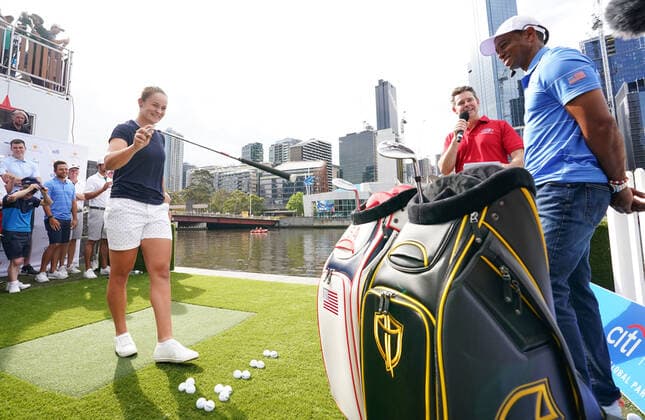 GOLF PRESIDENTS CUP, Ashleigh Barty prepares to play a golf shot as U.S. team Tiger Woods looks on during the Official Opening of the Presidents Cup before the 2019 Presidents Cup golf competition at Crown Riverwalk in Melbourne, Monday, December 9, 2019. ( NO ARCHIVING, EDITORIAL USE ONLY, NO USE IN BOOKS WITHOUT CONSENT MELBOURNE VIC AUSTRALIA  Copyright: xSCOTTxBARBOURx 20191209001437015422