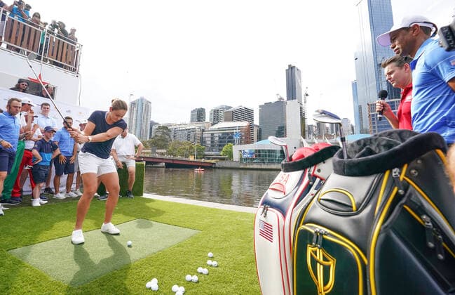 GOLF PRESIDENTS CUP, Ashleigh Barty prepares to play a golf shot as U.S. team Tiger Woods looks on during the Official Opening of the Presidents Cup before the 2019 Presidents Cup golf competition at Crown Riverwalk in Melbourne, Monday, December 9, 2019. ( NO ARCHIVING, EDITORIAL USE ONLY, NO USE IN BOOKS WITHOUT CONSENT MELBOURNE VIC AUSTRALIA  Copyright: xSCOTTxBARBOURx 20191209001437015453