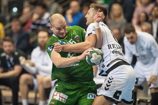 Paul Drux GER 95 Foxes Berlin powerfully sets itself against Harald Reinkind GER 6 THW Kiel through action game scene landscape horizontal event event foxes Berlin vs. THW Kiel HBL Handball Bundesliga 2019 20 17 game day location location Max Schmeling Halle Berlin Germany Germany Europe Date 12 12 2019 Stiehl Photography
