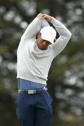 GOLF PRESIDENTS CUP, Playing Captain Tiger Woods of the United States team stretches on the second hole during the Friday four-ball matches on day two of the 2019 Presidents Cup golf tournament at the Royal Melbourne Golf Club in Melbourne, Friday, December 13, 2019. ( NO ARCHIVING, EDITORIAL USE ONLY, NO USE IN BOOKS WITHOUT CONSENT MELBOURNE VIC AUSTRALIA  Copyright: xROBxPREZIOSOx 20191213001437728342
