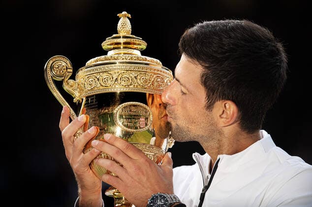191220 This picture is part of Bildbyran?s selection of the 100 best sports photos from 2019 Originally published 20190714 Novak Djokovic of Serbia kisses the Men s Singles Trophy after winning Men s Singles final during day 13 of Wimbledon on July 14, 2019 in London, Great Britain Photo Joel Marklund Bildbyran for AELTC kod JM 87988 bbeng wimbledon wimbledon 2019 tennis topx jubel,  Copyright: JOELxMARKLUND BB191220JM020