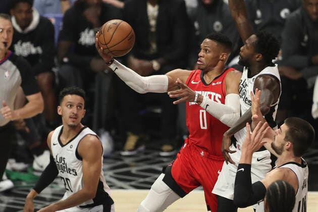 LOS ANGELES, CA - DECEMBER 19: Houston Rockets guard Russell Westbrook (0) goes up for layup after driving past LA Clippers guard Patrick Beverley (21) in the game between the Houston Rockets and the Los Angeles Clippers on December 19, 2019, at STAPLES Center in Los Angeles, CA. (Photo by Peter Joneleit Icon Sportswire) NBA, Basketball Herren, USA DEC 19 Rockets at Clippers Icon191219012