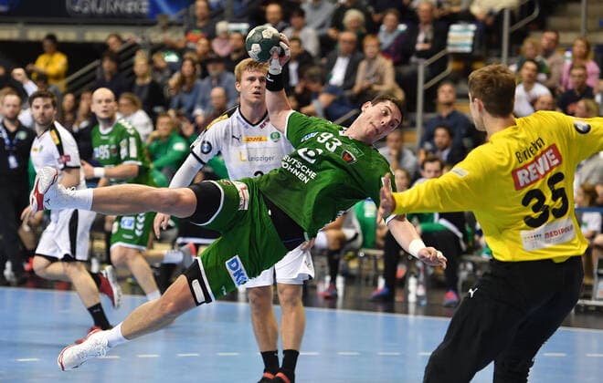 Mijajlo Marsenic Füchse , at the throw, front Joel Birlehm goalkeeper Leipzig , back Franz Semper Leipzig , Füchse Berlin SC DHFK Leipzig 1 Bundesliga, DKB Handballbundesliga, 2019 2020 Men, Men, Men, Handball, Germany, Germany, Max Schmeling Halle Berlin, 26 12 2019