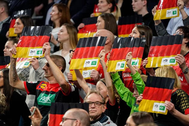 Fans of the German selection hold the German flag in their hands, fans, audience, spectators, mood, atmosphere, stadium, symbol photo, symbol image, symbol, 04 01 2020, Mannheim Germany, handball, international, Germany Iceland xozx