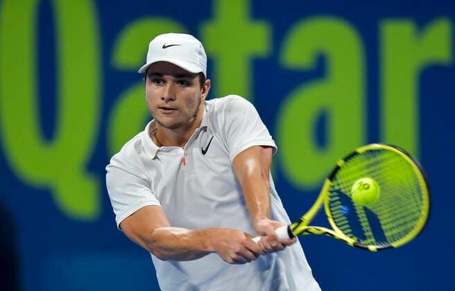 (200110) -- DOHA, Jan. 10, 2020 (Xinhua) -- Miomir Kecmanovic of Serbia returns the ball during the singles quarterfinal match against Marton Fucsovics of Hungary at ATP, Tennis Herren Qatar Open tennis tournament in Doha, Qatar, Jan. 9, 2020. (Photo by Nikku Xinhua) (SP)QATAR-DOHA-ATP-TENNIS-QATAR OPEN 