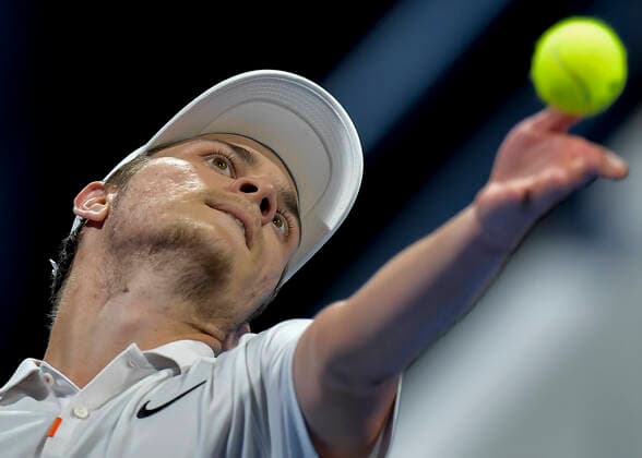 (200110) -- DOHA, Jan. 10, 2020 (Xinhua) -- Miomir Kecmanovic of Serbia serves during the singles quarterfinal match against Marton Fucsovics of Hungary at ATP, Tennis Herren Qatar Open tennis tournament in Doha, Qatar, Jan. 9, 2020. (Photo by Nikku Xinhua) (SP)QATAR-DOHA-ATP-TENNIS-QATAR OPEN 