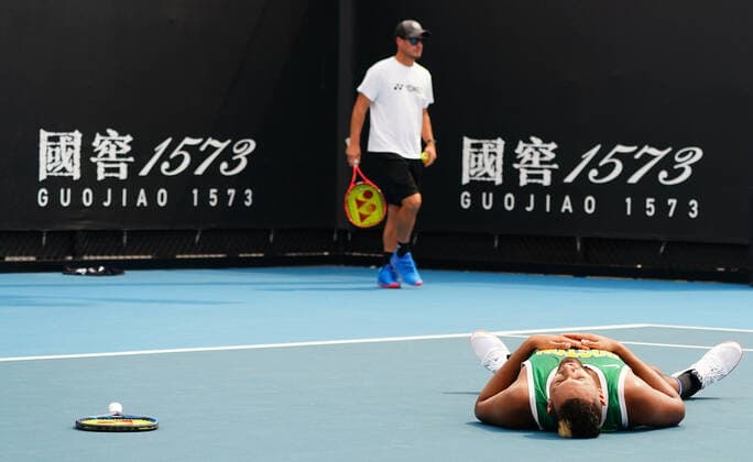 TENNIS AO PRACTICE PREVIEW, Nick Kyrgios of Australia collapses at the end of his session as Lleyton Hewitt looks on during an Australian Open practice session at Melbourne Park in Melbourne, Saturday, January 18, 2020. ( NO ARCHIVING, EDITORIAL USE ONLY, NO USE IN BOOKS WITHOUT CONSENT MELBOURNE VIC AUSTRALIA  Copyright: xSCOTTxBARBOURx 20200118001442900114