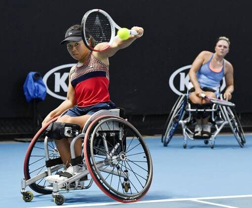 Tennis: Australian Open Japan s Yui Kamiji (L) plays a shot, alongside Jordanne Whiley of the United Kingdom, in the women s wheelchair doubles final against Diede de Groot and Aniek van Koot of the Netherlands at the Australian Open tennis tournament in Melbourne on Jan. 31, 2020. 