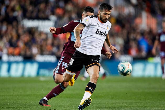 1st February 2020; Mestalla, Valencia, Spain; La Liga Football,Valencia versus Celta Vigo; Ezequiel Garay of Valencia CF brings the ball forward challenged by Gabriel Fernandez of Celta  ActionPlus12208891 IvanxArlandis