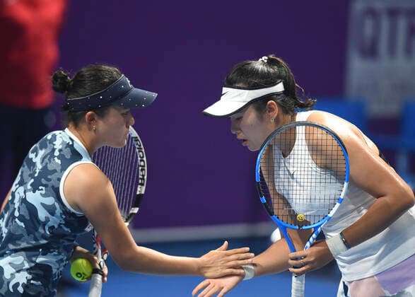 (200224) -- DOHA, Feb. 24, 2020 (Xinhua) -- Yang Zhaoxuan (R) of China and her partner Makoto Ninomiya of Japan cheer up with each other during the women s doubles first round match against Hayley Carter of the United States and Luisa Stefani of Brazil at 2020 WTA, Tennis Damen Qatar Open tennis tournament in Doha, Qatar, Feb. 23, 2020. (Photo by Nikku Xinhua) (SP)QATAR-DOHA-TENNIS-WTA-DOUBLES 