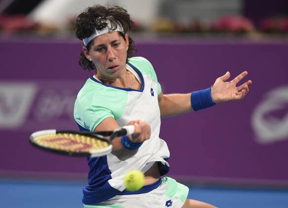 (200226) -- DOHA, Feb. 26, 2020 (Xinhua) -- Carla Suarez Navarro of Spain hits a return during the women s singles second round match against Petra Kvitova of the Czech Republic at the 2020 WTA, Tennis Damen Qatar Open in Doha, Qatar, Feb. 25, 2020. (Photo by Nikku Xinhua) (SP)QATAR-DOHA-TENNIS-WTA-SINGLES 