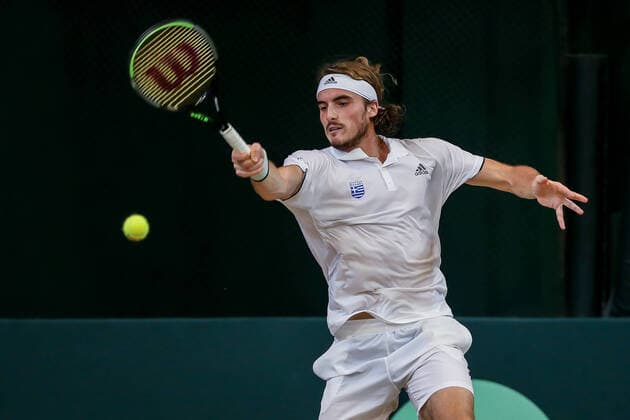 (200307) -- MANILA, March 7, 2020 -- Stefanos Tsitsipas of Greece competes against Jeson Patrombon of the Philippines during the Davis Cup World Group II Play-Offs First Round doubles match between the Philippines and Greece in Manila, the Philippines on March 7, 2020. ) (SP)PHILIPPINES-MANILA-TENNIS-DAVIS CUP-GREECE VS PHILIPPINES ROUELLExUMALI 