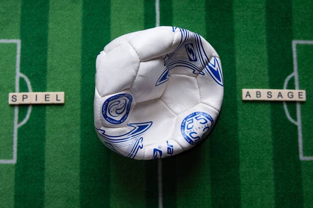 Germany 13 03 2020 Symbolic images Coronavirus The coronavirus causes event cancellations of football matches of Bundesliga professionals, concerts or schools are closed Here A broken football with the word match cancellation on a football carpet Germany