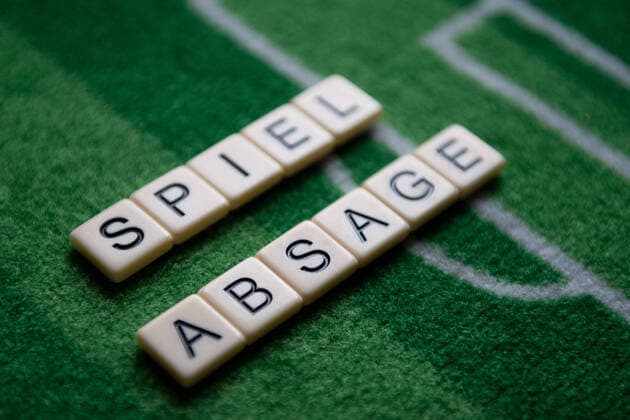Germany 13 03 2020 Symbolic images Coronavirus The coronavirus causes event cancellations of football matches of Bundesliga professionals, concerts or schools to be closed Here The word game cancellation on a football carpet Germany