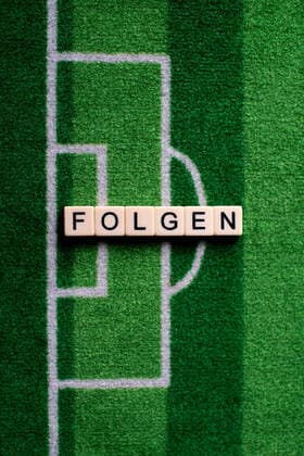 The corona virus Covid 19 causes event cancellations of, for example, soccer matches of Bundesliga professionals for an indefinite period of time and many effects, in the picture The word Folgen auf einem Fußballteppich Germany