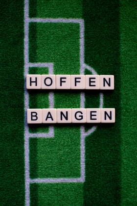 The corona virus Covid 19 causes events such as football matches of Bundesliga professionals to be cancelled indefinitely and has many consequences, in the picture The word hope and fear on a football carpet Germany