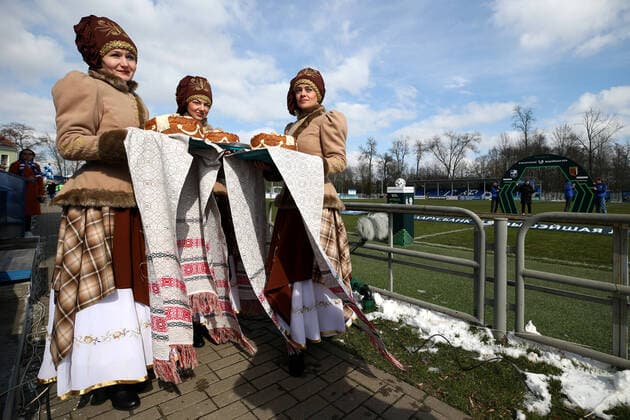 MINSK REGION, BELARUS - MARCH 22, 2020: Women in ethnic costumes seen ahead of a 2020 Belarusian Football Cup match between FC Slutsk and Slavia Mazyr at the City Stadium in the town of Slutsk. The Belarusian Football Federation has decided not to cancel the new season of the tournament amid the COVID-19 coronavirus pandemic. Natalia Fedosenko TASS  TS0D306E